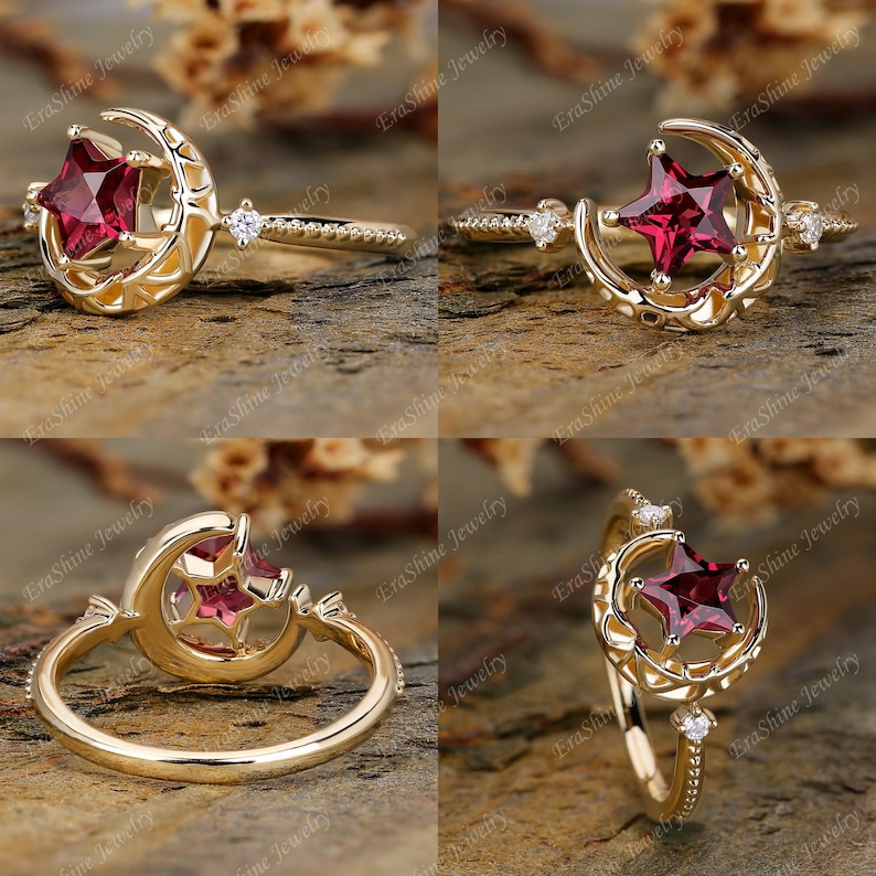 K&ouml;nnte beinhalten: Ein goldener Ring mit einem Halbmond-Design und einem roten Edelstein, der in eine Sternform gefasst ist. Der Ring ist mit kleinen Diamanten verziert.