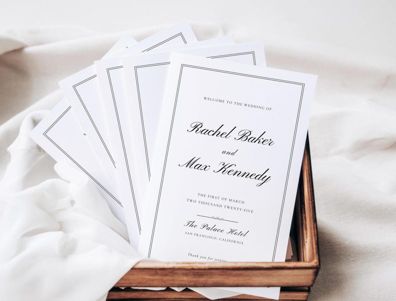 May include: A stack of white wedding programs with black text. The programs announce the wedding of Rachel Baker and Max Kennedy, taking place on the first of March, two thousand twenty-five at The Palace Hotel in San Francisco, California.