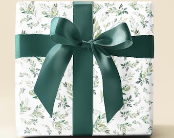 May include: A white gift box with a green floral pattern and a green satin ribbon tied in a bow.
