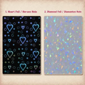 May include: Two rectangular sheets of foil. The first sheet is black with a repeating pattern of glowing blue heart outlines and small circular accents labelled 1. Heart Foil. The second sheet is translucent with a holographic diamond pattern labelled 2. Diamond Foil.