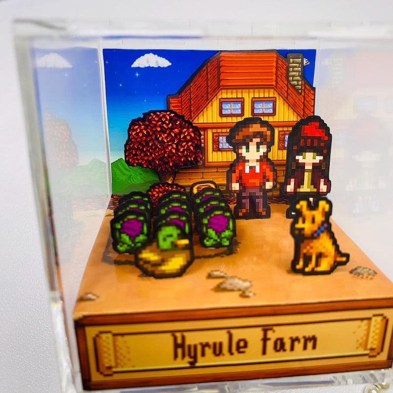 May include: A pixelated diorama featuring a farm scene with a house, two characters, a dog, and crops. The scene is set against a blue sky with a cloud. The base of the diorama reads "Hyrule Farm".