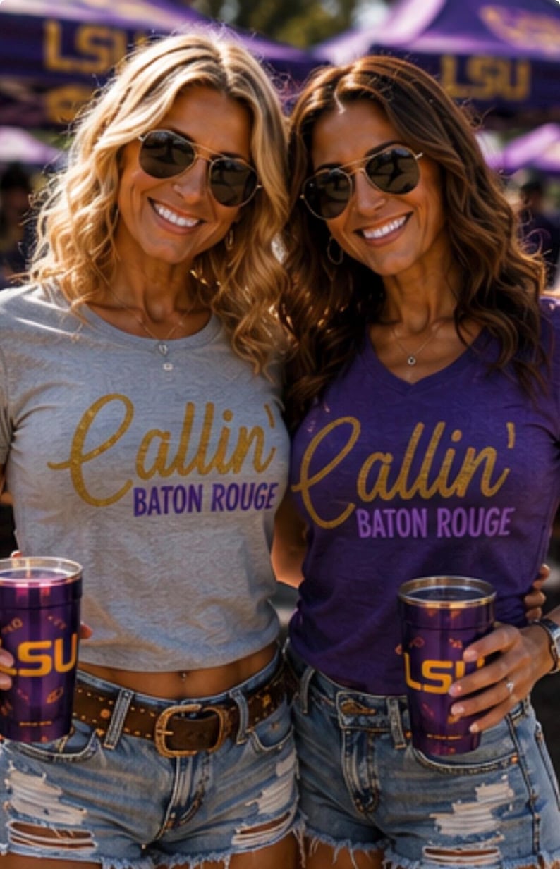 Puede incluir: Una camiseta gris y una camiseta morada, ambas con el texto dorado Callin' Baton Rouge en letras moradas y doradas. Cada prenda se combina con pantalones cortos de mezclilla azul y un vaso morado con el logotipo amarillo LSU impreso.