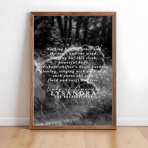 May include: Black and white framed art print featuring a leopard in a natural setting. The print includes the text "Nothing but the grass and the trees and the wind...Lady of Caraver, Lysandra, The Shapeshifter."