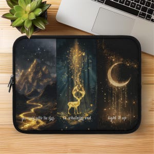 May include: Black laptop sleeve with a celestial design. It features mountains, a deer, and a crescent moon, all lit with golden light. The text reads "you could rattle the stars", "to whatever end", and "light it up".
