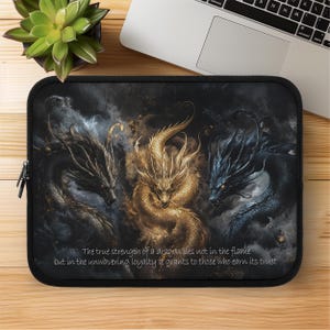 May include: Black laptop sleeve featuring three detailed dragons in gold, black, and blue. The dragons are set against a dark, smoky background. Text at the bottom reads, "The true strength of a dragon lies not in the flame but in the unwavering loyalty it grants to those who earn its trust."