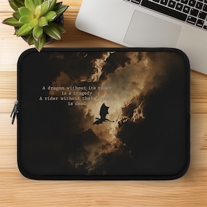May include: Black laptop sleeve featuring a dragon silhouette soaring against a dramatic cloudy sky. The text reads: "A dragon without its rider is a tragedy. A rider without their dragon is dead."