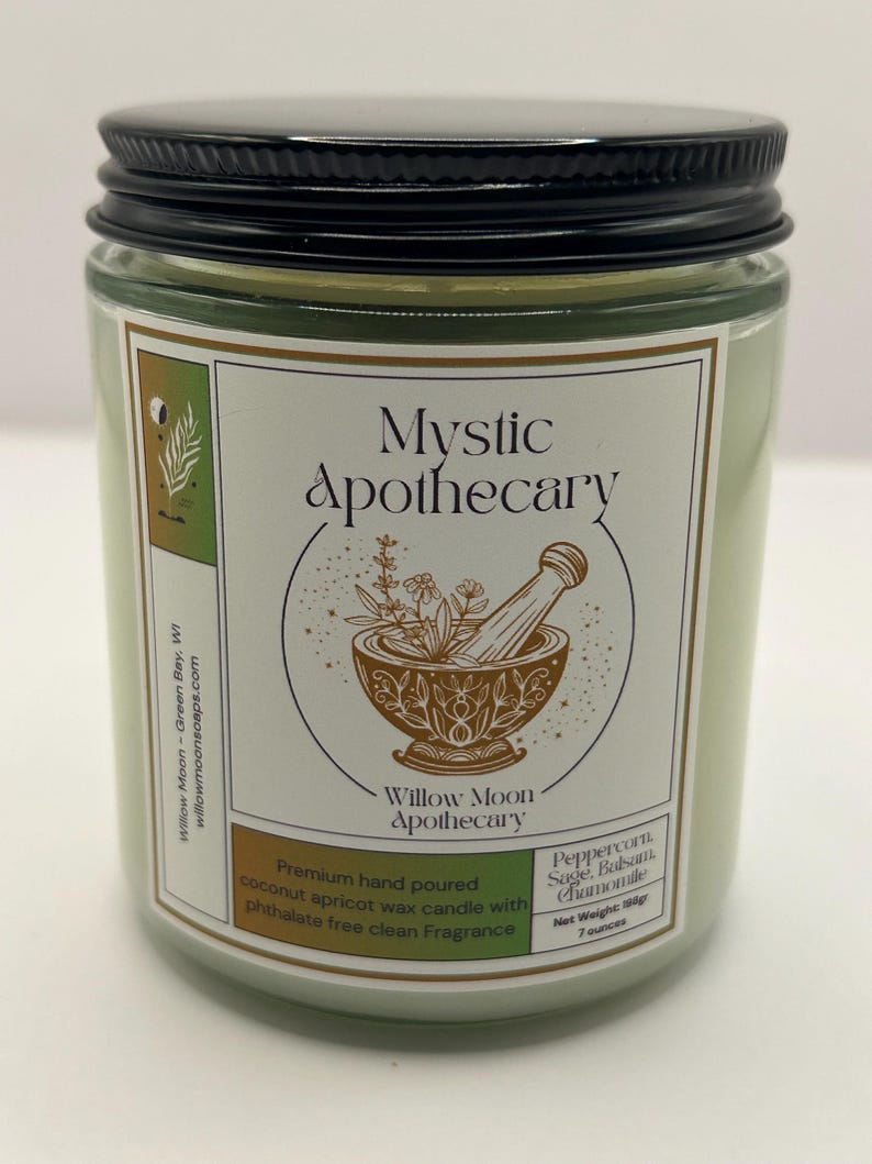 May include: A light green candle in a clear glass jar with a black metal lid. The label reads Mystic Apothecary, Willow Moon Apothecary, and lists Peppercorn, Sage, Balsam, Chamomile, with a net weight of 198g and 7 ounces, featuring a mortar and pestle.