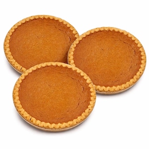 May include: Three round pumpkin pies with golden-brown crusts and a smooth, orange filling. The pies are presented on a white background, showcasing their fresh-baked appearance. The crusts have a decorative, scalloped edge.