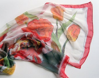 May include: A white silk scarf with a red border and a floral print of red, yellow, and green tulips.