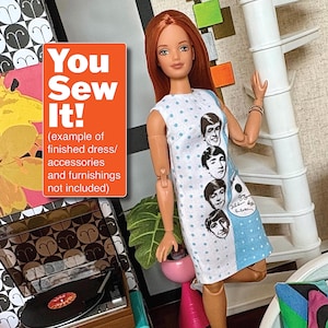 May include: A doll wearing a white dress with blue polka dots and a blue panel featuring the faces of The Beatles. The dress has a sleeveless design. The image includes the text "You Sew It!" in an orange box.