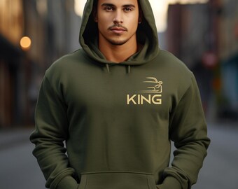 May include: A green hooded sweatshirt with a gold car silhouette and the word "KING" printed on the front.