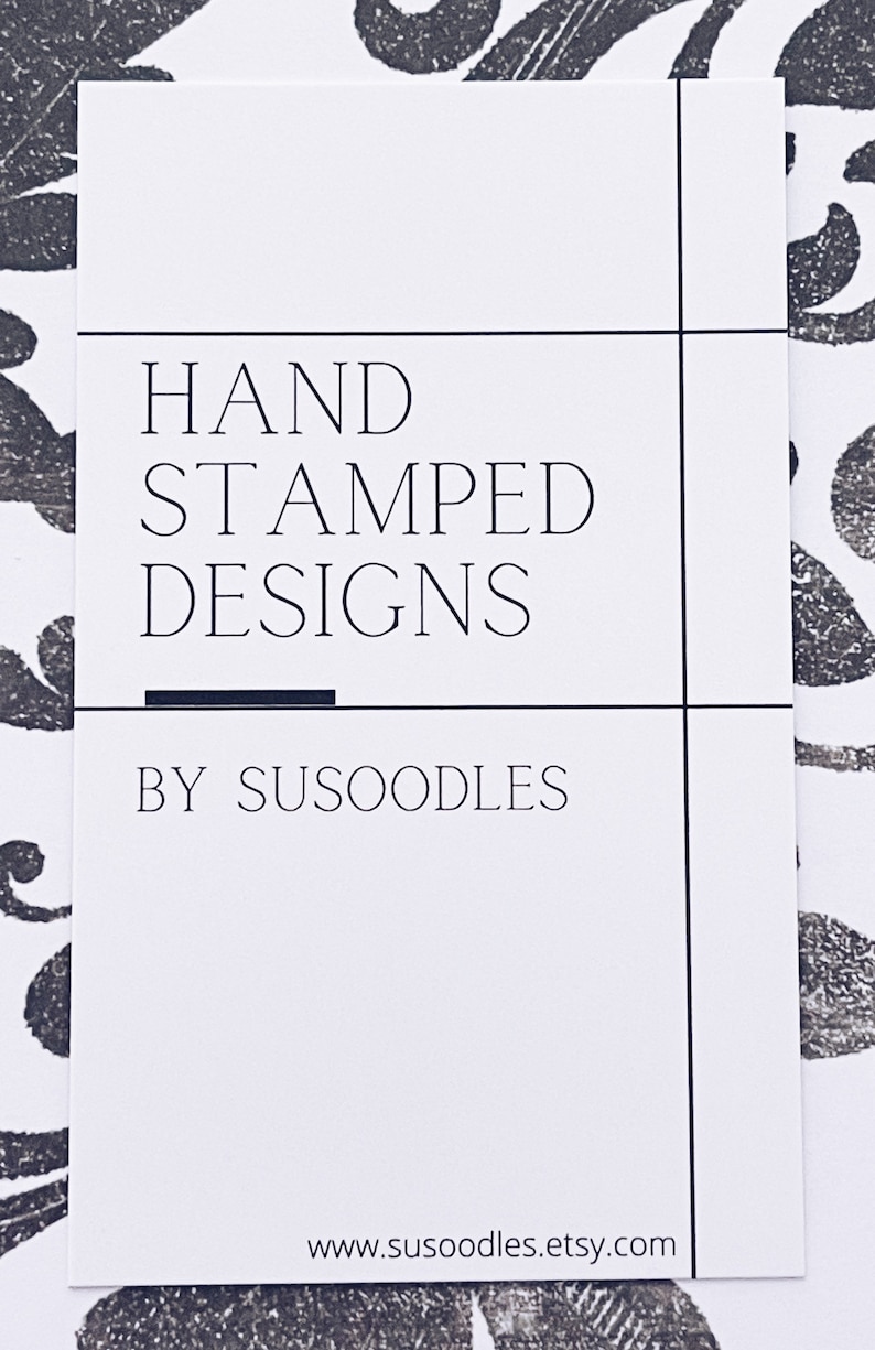 May include: A white card with black text that reads "HAND STAMPED DESIGNS BY SUSOODLES" and a website address: www.susoodles.etsy.com