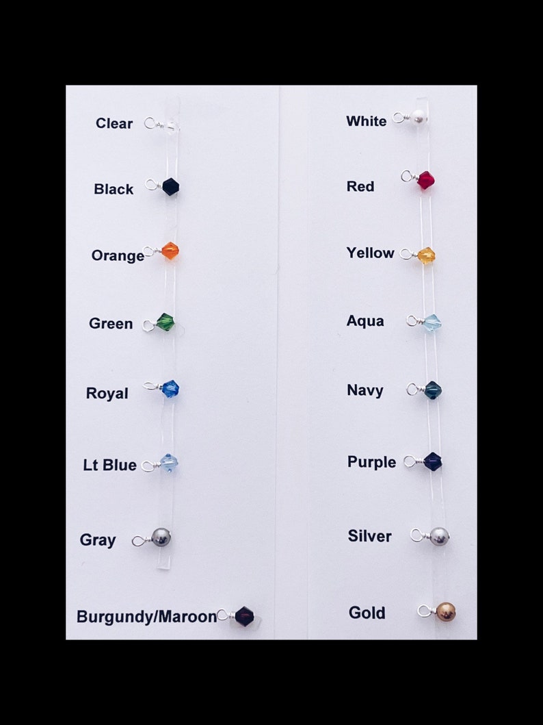 May include: A color chart with 10 different colored beads and their corresponding names. The colors include clear, black, orange, green, royal blue, light blue, gray, burgundy/maroon, white, red, yellow, aqua, navy, purple, silver, and gold.