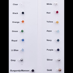 May include: A color chart showing different colored beads and charms for jewelry making. The colors include clear, black, orange, green, royal blue, light blue, gray, burgundy/maroon, white, red, yellow, aqua, navy, purple, silver, and gold.