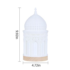 May include: White ceramic table lamp with a dome-shaped shade featuring intricate cutouts. The lamp is 9.92 inches tall and 4.72 inches wide.