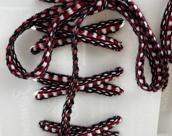 45” pair of shoelaces.  Black, red and white. Tips are metallic silver.