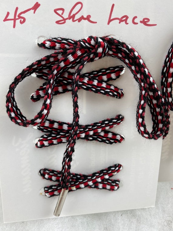 white shoelaces with red tips