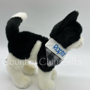 May include: A plush black and white cat toy with a blue embroidered name tag that says "Raptor". The cat has a black and white checkered bandana. The toy is from Country Club Gifts.