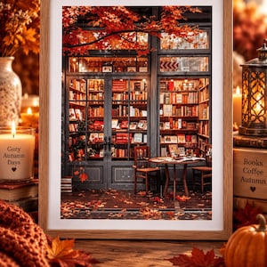 May include: A framed print depicting a bookstore storefront with glass doors and windows filled with bookshelves, illuminated by warm interior lighting. Red maple leaves hang above the entrance, and fallen leaves cover the ground.