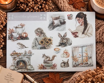 May include: A sticker sheet featuring watercolor illustrations of autumn themes, including a fireplace, pumpkins, a rabbit, a squirrel on books, a person reading, a person holding sunflowers, a bird, a teapot, and a window view with curtains.