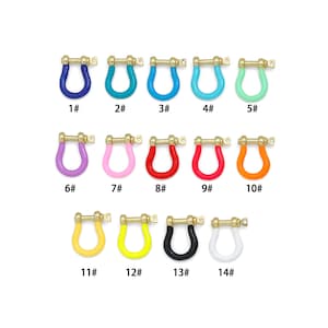 May include: A collection of fourteen U-shaped metal shackles with gold-tone hardware and colorful enamel coatings. Each shackle is labeled with a number from 1# to 14#, featuring colors including dark blue, teal, light blue, mint, purple, pink, red, orange, yellow, black, and white.