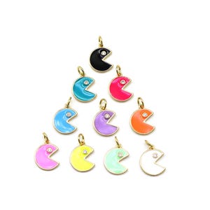 May include: Assortment of ten enamel Pac-Man charms in various colors, each with a single rhinestone eye. The charms are gold-toned and have a shiny finish.