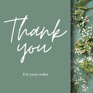 May include: A green card with white text that says "Thank you" and "For your order". The card is surrounded by white flowers and green leaves.