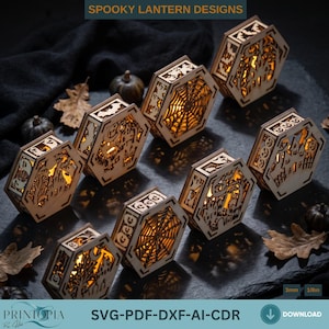 May include: A collection of eight hexagonal wooden lanterns featuring intricate laser-cut Halloween designs including spider webs, bats, pumpkins, and haunted houses. Each lantern is illuminated from within with a warm light, displaying the text SPOOKY LANTERN DESIGNS and 3mm 1/8in.