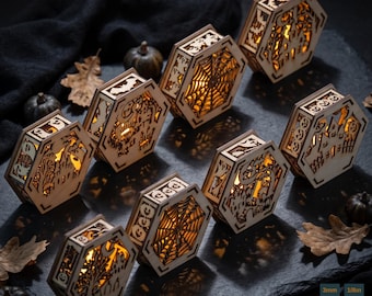 May include: A collection of eight hexagonal wooden lanterns featuring intricate laser-cut Halloween designs including spider webs, bats, pumpkins, and haunted houses. Each lantern is illuminated from within with a warm light, displaying the text SPOOKY LANTERN DESIGNS and 3mm 1/8in.