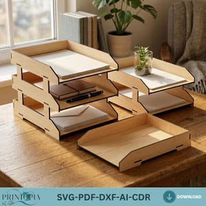 Puede incluir: Organizadores de escritorio de madera con múltiples bandejas, que contienen papel, cuadernos y sobres. Los organizadores son de madera clara y están apilados. La imagen también incluye una sola bandeja y el texto "SVG-PDF-DXF-AI-CDR".