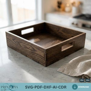 May include: A dark brown wooden tray with cut-out handles. The tray is rectangular and has a smooth, polished finish. The text "SVG-PDF-DXF-AI-CDR" is visible at the bottom of the image. A beige cloth is on the right side of the tray.
