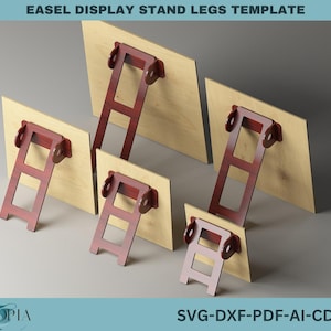 May include: Five different sizes of easel display stand legs templates. The templates are made of wood and have a brown finish. The legs are made of metal and have a red finish. The text "SVG-DXF-PDF-AI-CDR" is printed at the bottom of the image.