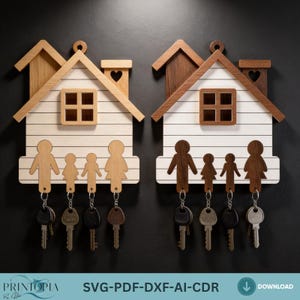 May include: Two wooden key holders shaped like houses, each with a family silhouette design. The houses have a white base with horizontal lines, a brown roof, and a heart-shaped chimney. Keys hang from the family figures.