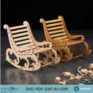 May include: Two miniature wooden rocking chairs, one light and one medium brown, are shown against a dark backdrop. The chairs feature a classic design with curved rockers, armrests, and slatted backs and seats. The image includes the text "SVG-PDF-DXF-AI-CDR".