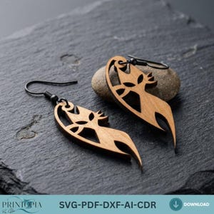 May include: Two wooden earrings with a leaf-like design and black ear wires. The earrings are a light brown color and have cut-out details. They are displayed on a dark gray, textured surface.