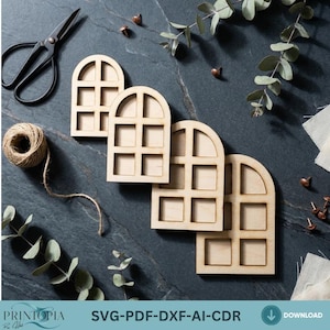 May include: Four unfinished wooden window cutouts with arched tops and square panes. A ball of twine, black scissors, and decorative elements are arranged on a dark gray surface. The text "SVG-PDF-DXF-AI-CDR" is visible.