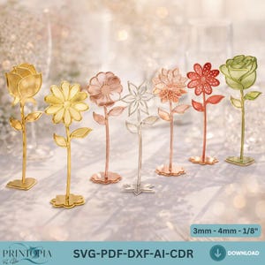 May include: A collection of six metal flower decorations in various colors, including gold, rose gold, and silver. Each flower has a stem and base. The image also includes the text "SVG-PDF-DXF-AI-CDR" and "3mm - 4mm - 1/8".