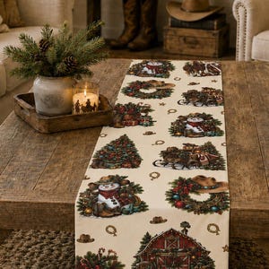 May include: A cream-coloured table runner featuring a repeating pattern of Christmas-themed illustrations including snowmen, decorated wreaths, red barns, cowboy boots, and horseshoes. The fabric has a smooth texture and a festive holiday design.
