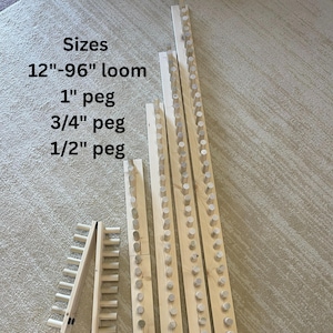 May include: Wooden weaving loom components with pegs. The image shows various sizes, including a 12"-96" loom, 1" peg, 3/4" peg, and 1/2" peg. The components are made of light-colored wood and are arranged on a neutral-toned surface.