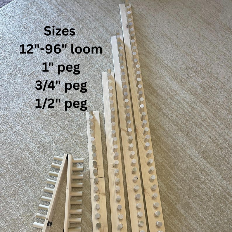 May include: Wooden weaving loom components with pegs. The image shows various sizes, including a 12"-96" loom, 1" peg, 3/4" peg, and 1/2" peg. The components are made of light-colored wood and are arranged on a neutral-toned surface.