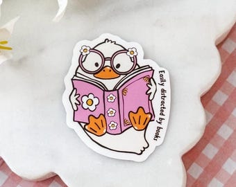 Easily Distracted By Books | adorable duck reading a book sticker | glossy waterproof sticker