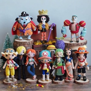 May include: A collection of eleven handmade crochet dolls representing various characters. The figures feature intricate yarn details, vibrant colors, and distinct outfits, standing on small wooden bases. They are arranged in a group display.
