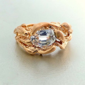 Modern Engagement ring. Unique engagement ring. 14k rose gold water ring. Oval white sapphire ring.