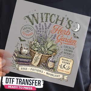 May include: A DTF transfer sheet featuring a graphic design with the text Witch's Herb Garden. The illustration includes a basket of lavender, a mortar and pestle, stacked books labeled Herbology, Potions, and Plants & Spells, and a bottle.