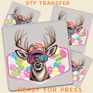May include: A DTF transfer design featuring a deer wearing sunglasses that say "EGG HUNTER" and a camouflage hat. The design is surrounded by colorful Easter eggs and the text "READY FOR PRESS".