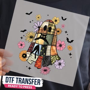 May include: A DTF transfer featuring a ghost figure made of various plaid and polka dot fabric patches. A black cat is visible through the ghost's eye holes. The design is surrounded by colourful flowers, small black bats, and star shapes.