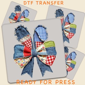 May include: DTF transfer design of a patchwork bow with denim, floral, and gingham patterns in red, blue, and green. The text "DTF TRANSFER" and "READY FOR PRESS" are displayed in orange.