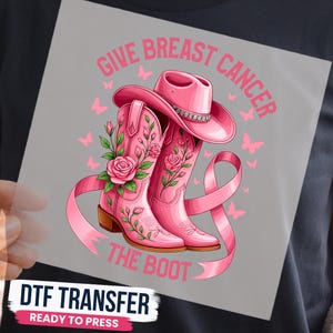 May include: A graphic design on a square sheet featuring a pink cowboy hat and two pink cowboy boots decorated with pink roses and green leaves. A pink ribbon wraps around the boots. The text reads GIVE BREAST CANCER THE BOOT with pink butterflies.