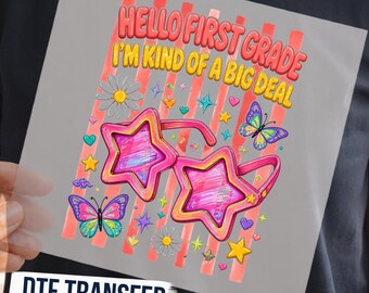May include: A DTF transfer sheet featuring the text HELLO FIRST GRADE I'M KIND OF A BIG DEAL in red and yellow. The design includes pink star-shaped sunglasses, colorful butterflies, daisies, and small stars on a background of vertical red stripes.
