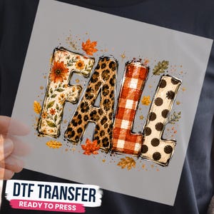 May include: A DTF transfer sheet featuring the word FALL in large block letters. The F has a floral pattern, the A has a leopard print, the L has a red and white buffalo plaid, and the second L has a black polka dot pattern, surrounded by autumn leaves.
